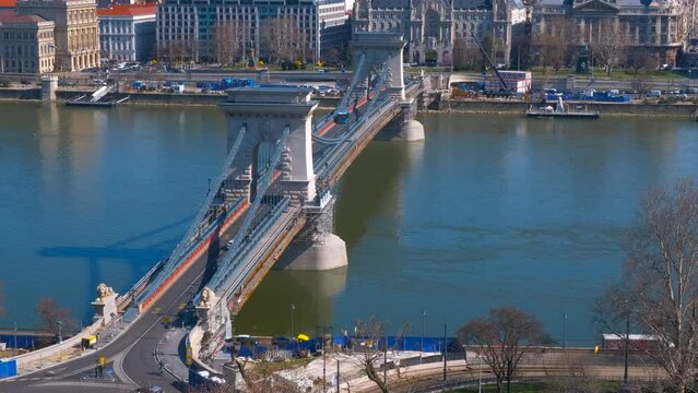 Secheny chain bridge. A view of Secheni bridge with public traffic over the Danube river in Budapest in the sun light.