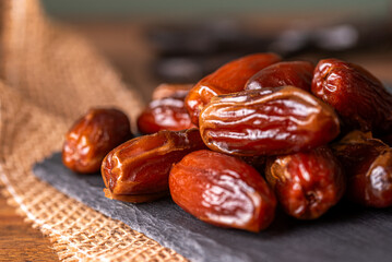 dried dates on a black stone board.