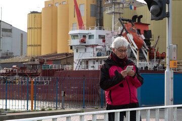 Portrait of a senior woman texting on her smartphone outdoors