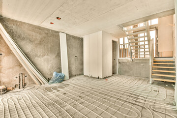 a living room under construction with stairs and a staircase