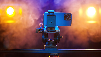 Multi-camera Smartphone on professional slider surrounded with spotlight