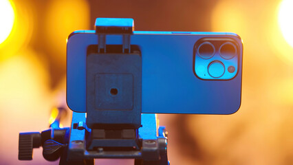 Professional multi-camera smartphone device on tripod with smoke in background