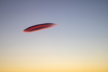 Red UFO like cloud with a dusk sky