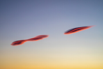 Red and grey UFO like clouds with dusk sky