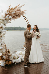 wedding ceremony of the newlyweds on the pier