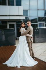 Fototapeta premium bride and groom first meeting on the roof of skyscraper