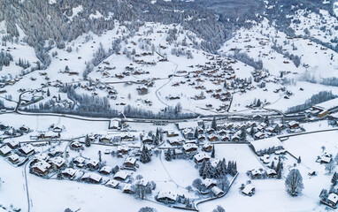 Aerial panorama view of Grindelwald villages with wooden chalets covered with snow in cold winter season in Swiss Alps