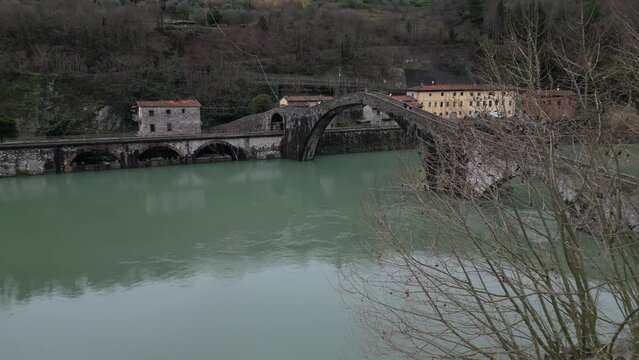 Devil's Bridge, Tuscany. Lucca. Suspension bridge over mirror water.
