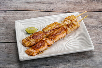 Grilled salmon skewer with sauce