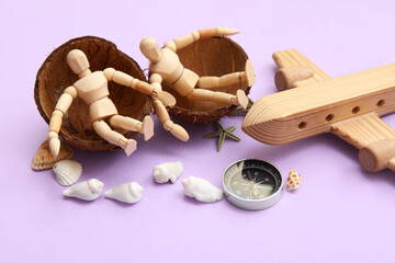 Composition with wooden plane, compass and mannequins sitting in coconut shell on lilac background