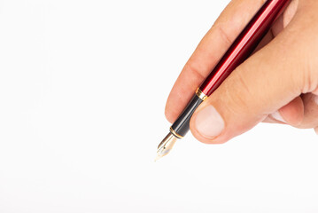 Fountain pen and hand, beautiful fountain pen in detail held in hand, with white background, selective focus.