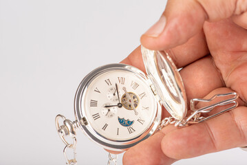Antique watch and hand, beautiful antique pocket watch held in hand with white background,...