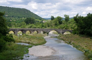 Fototapeta na wymiar Ancient bridge in Ardeche in the South East of France, in Europe