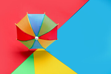 Colorful mini umbrella on color background
