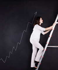 a woman is climbing a ladder on a blackboard