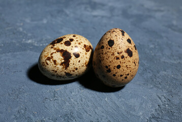 Fresh quail eggs on blue background