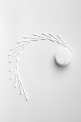 Cotton swabs buds and cotton pads on a white background.