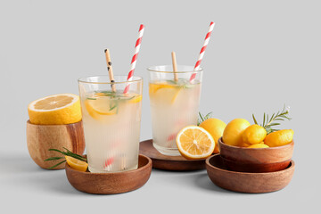 Glasses with fresh lemonade on grey background
