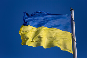 National flag of Ukraine against blue sky