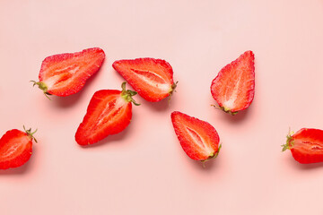 Slices of fresh strawberries on pink background