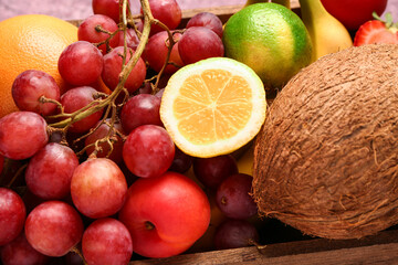 Wooden box with different fresh fruits, closeup