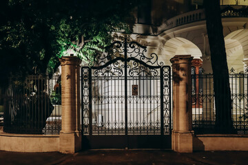 Beautiful lattice at the entrance to a building in Rome at night
