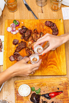 people drinking gin and Russian vodka at the table with shish kebab and a good appetizer, photo top view