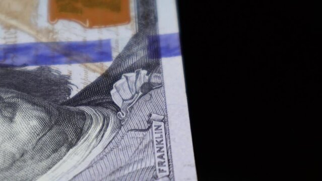 Extreme closeup of The US Dollar bill's security feature of color shifting ink