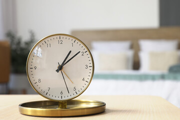 Alarm clock on bedside table in bedroom, closeup