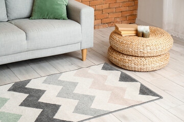 Interior of modern living room with stylish carpet and grey sofa