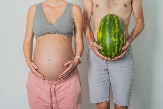 A humorous image: a pregnant woman and her husband playfully use a watermelon in place of a belly, comically highlighting the challenges of navigating with a pregnant bump