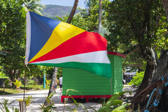 Flag of Seychelles waving on wind on a summer day