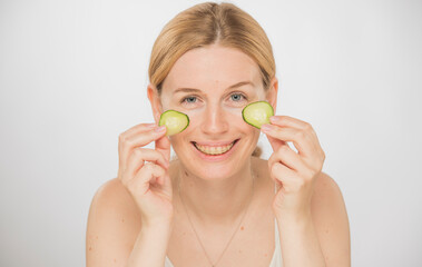 girl with cucumbers for a mask