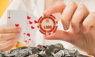 background banner with playing cards and chips. female hands holding a poker chip and cards