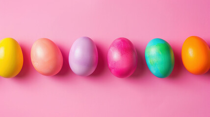 Fototapeta na wymiar Easter eggs on vibrant pinkn background, copy space