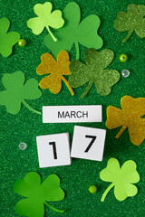 March 17 calendar and green clover leaves top view. St. Patrick's Day concept