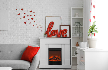 Word LOVE made from balloons on fireplace in festive living room. Valentine's Day celebration