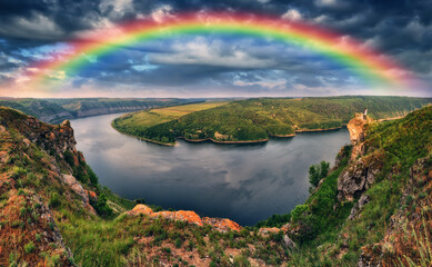 Rainbow over the river Dnister. Landscape with a rainbow in the sky. Nature of Ukraine