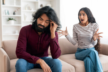 Emotional young indian woman gesturing and shouting at boyfriend