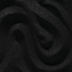 Zen lines of dark black sand. Curved ripples of smooth volcanic sand texture or wallpaper. Wave pattern in black sand background.