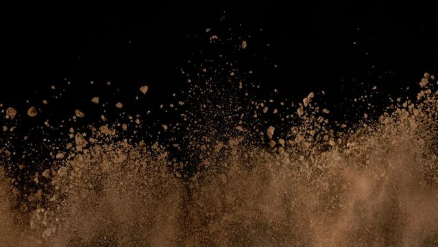 Super Slow Motion Shot of Soil Explosion Isolated on Black Background at 1000fps.