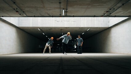 Panorama shot of hipster group dance together while perform b-boy dance. Street dancer team moving...