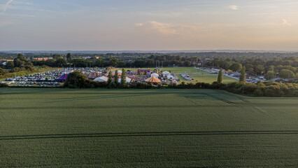 Aerial Drone View of a Festival with Tent in the Background of a Field