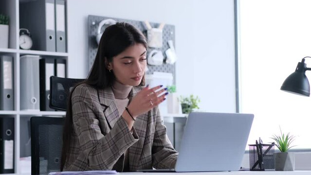 In a moment of frustration or disbelief, a Caucasian businesswoman facepalms while working with laptop in the office. This image captures the nuanced reactions and expressions that may arise.