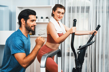 Fototapeta na wymiar Athletic and sporty young couple or fitness buddy running on running machine together, home body workout exercise session as healthy sport lifestyle at home. Gaiety home exercise workout training.