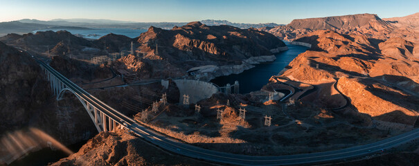 Hoover Dam on the Colorado River straddling Nevada and Arizona at dawn from above. Aerial view of...