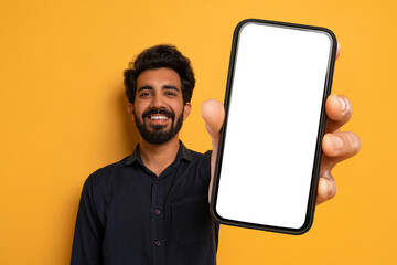 Cheerful Indian Man Showing Big Phone With White Blank Screen - obrazy, fototapety, plakaty