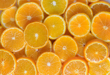 juicy tangerines cut into circles as a background 7