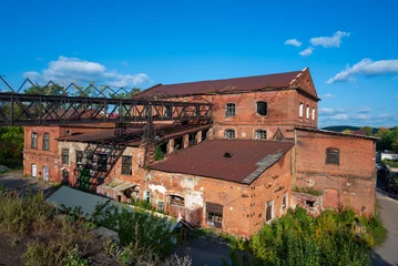 Foto op Plexiglas An old abandoned brick factory against a bright sky © евгений ставников