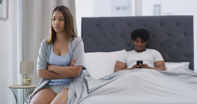 Angry, couple and conflict from fight in the bedroom in home or thinking about divorce, depression and erectile dysfunction. Woman, stress and man with sex problem or anxiety in marriage from phone